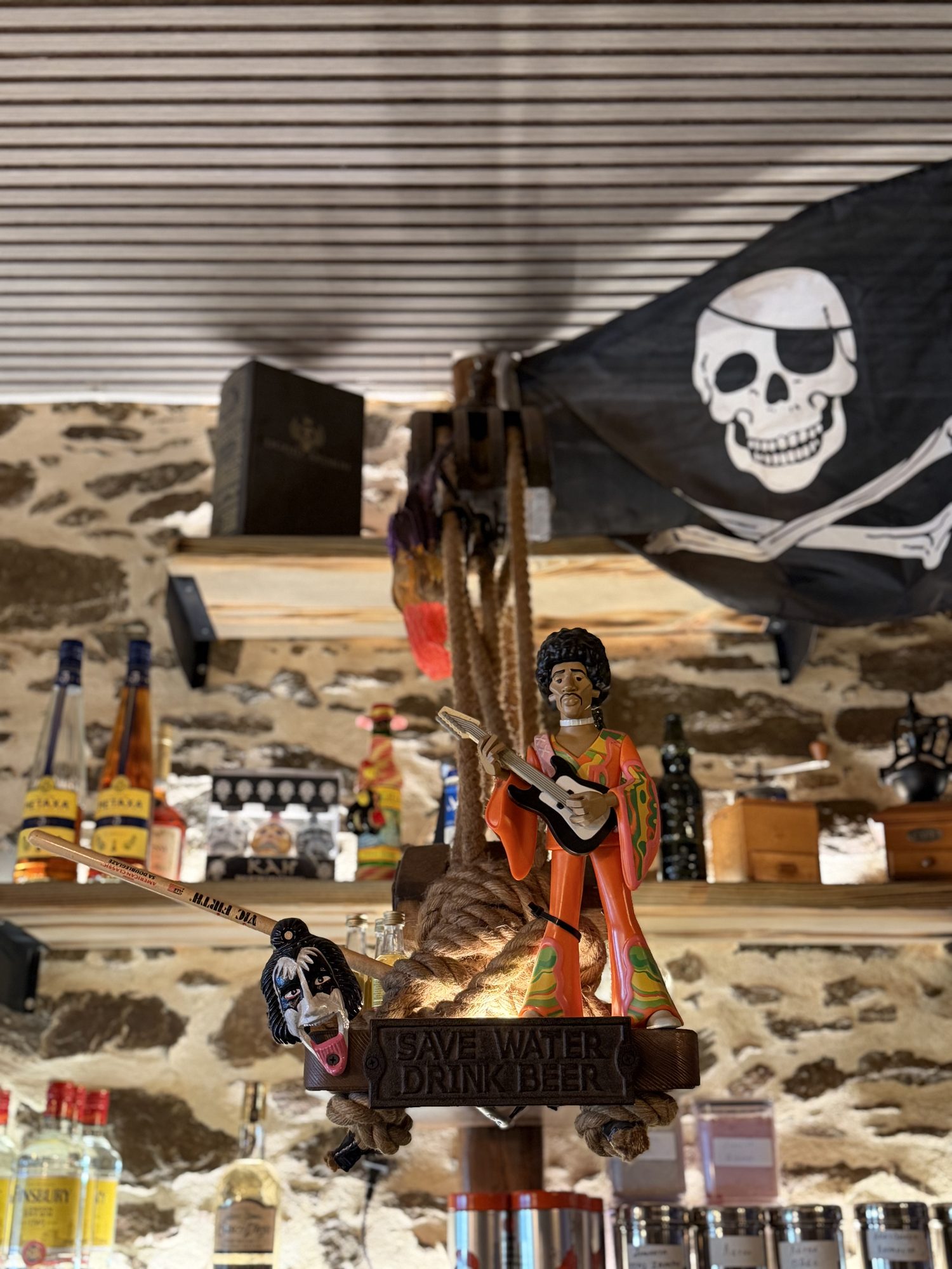 Jolly Roger flag hanging above a Jimi Hendrix figurine on the bar