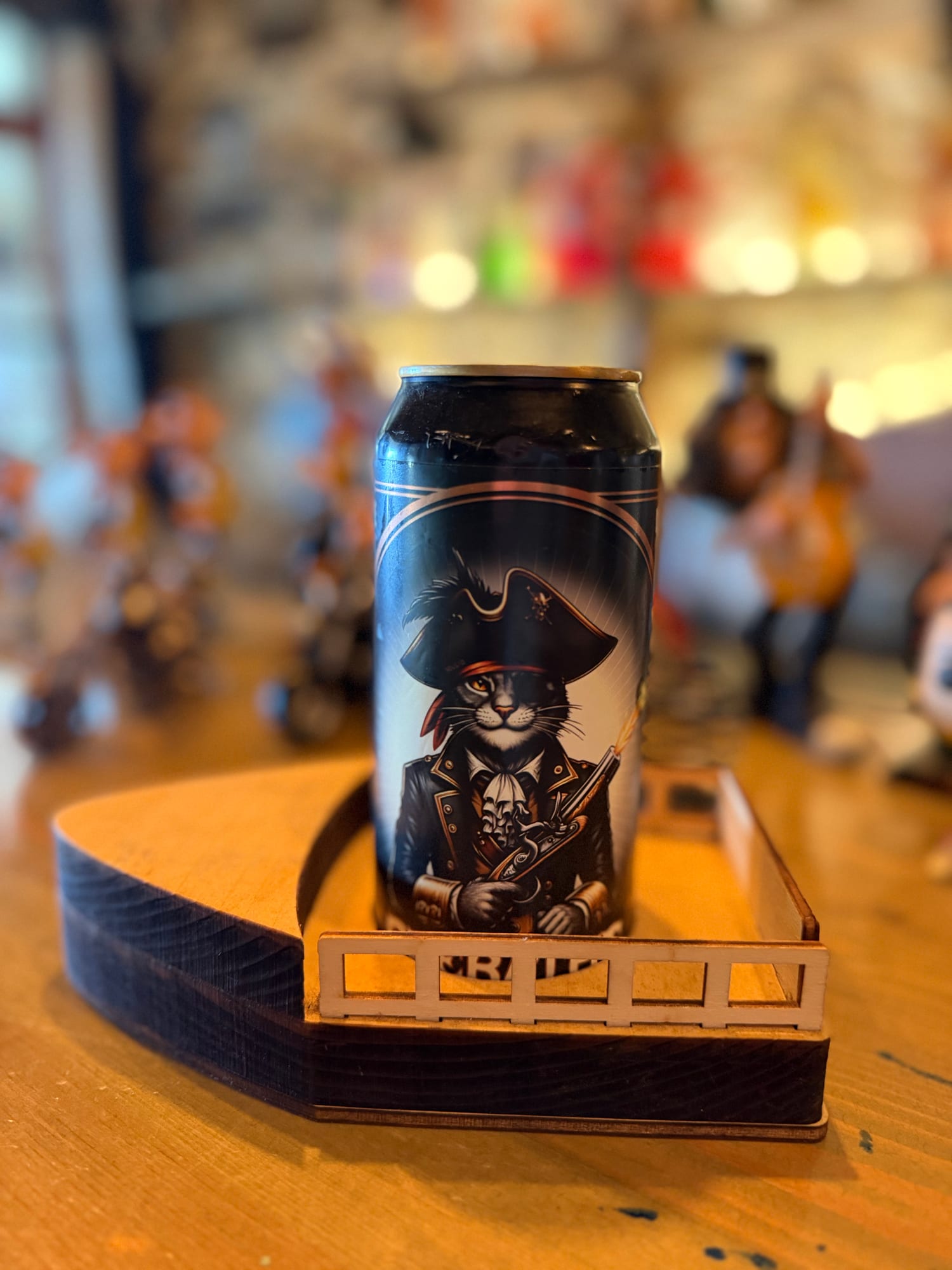 Pirate-themed rum can resting in a carved wooden ship holder