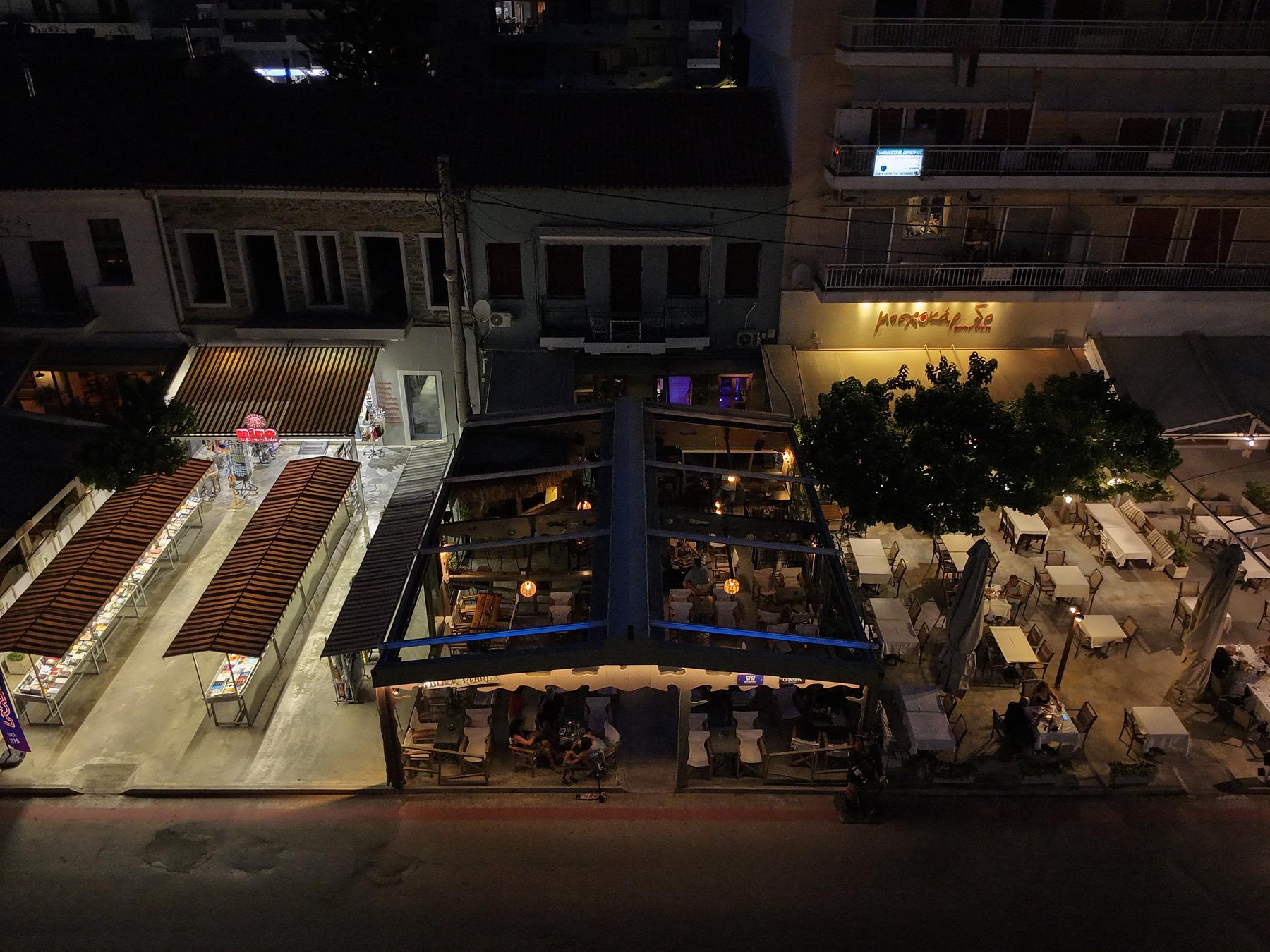 Aerial night view of the lit-up Black Pearl terrace and seafront street